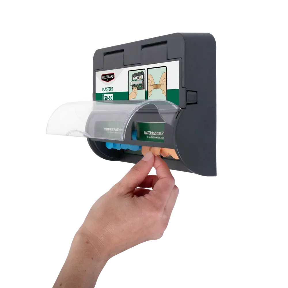 Vegghengt plasterdispenser med hånd som tar ut plaster, førstehjelpsutstyr